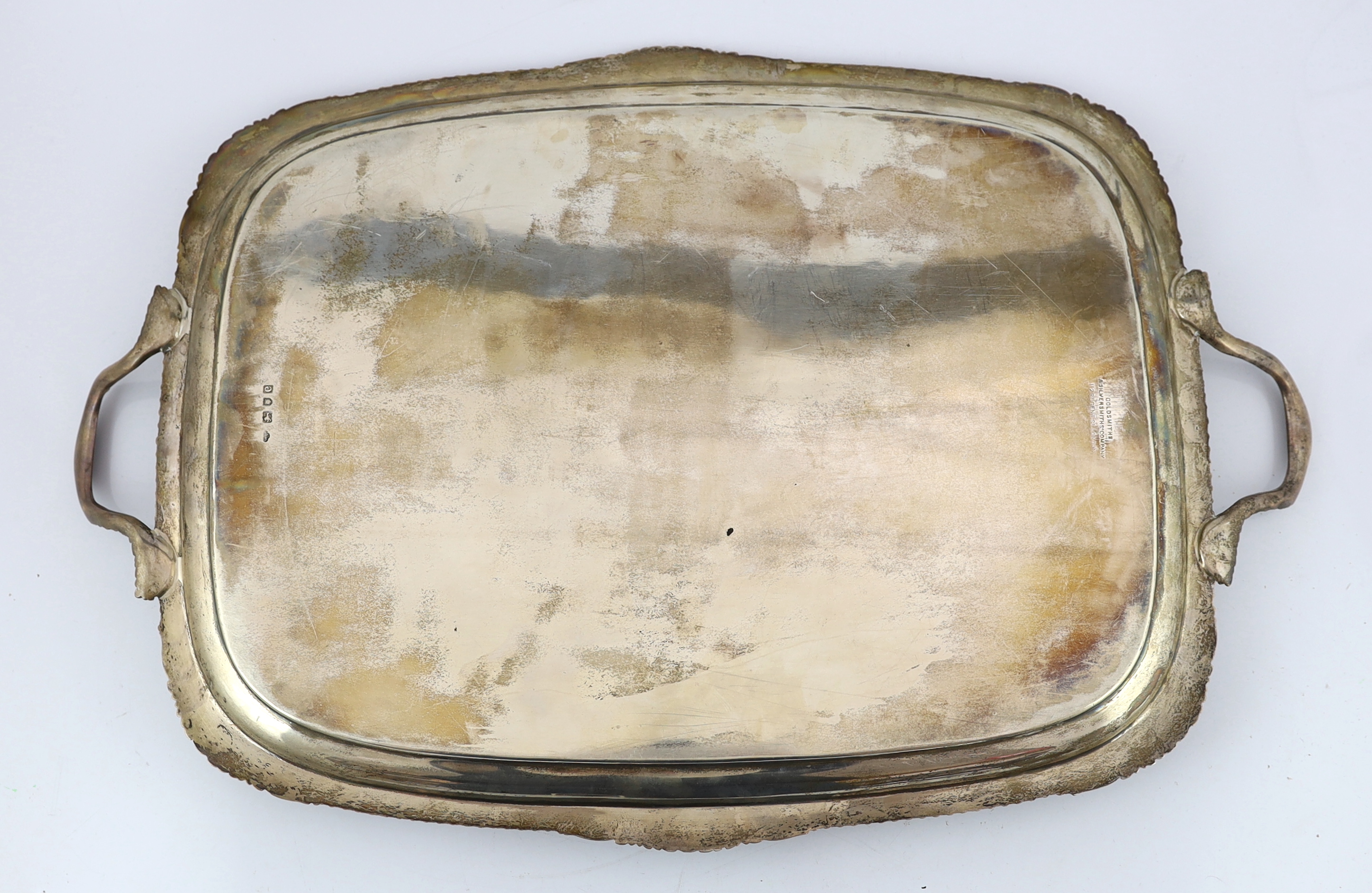 A late Victorian silver two handled rounded rectangular tea tray, by Goldsmiths & Silversmiths Co. Ltd